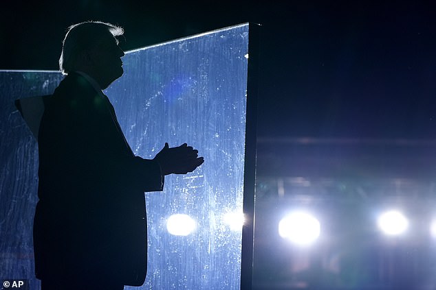 Former Republican presidential candidate Donald Trump listens as Christopher Macchio, not pictured, sings at the end of a campaign event at the Butler Farm Show, Saturday, Oct. 5, 2024.