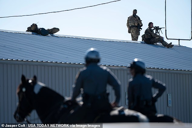 Secret Service snipers survey from an elevated position before former President Donald Trump speaks at a campaign rally in Butler, Pennsylvania, on October 5, 2024.