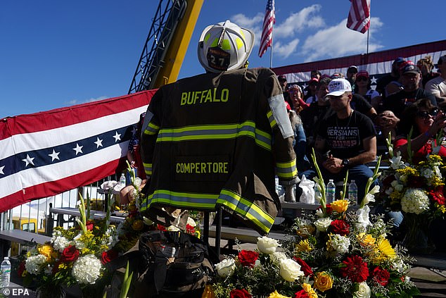 A memorial to firefighter Corey Comperatore, who was killed during an assassination attempt on Republican presidential candidate and former US President Donald Trump, on display before a campaign rally with President Trump at the Butler Farm Show in Butler, Pennsylvania.