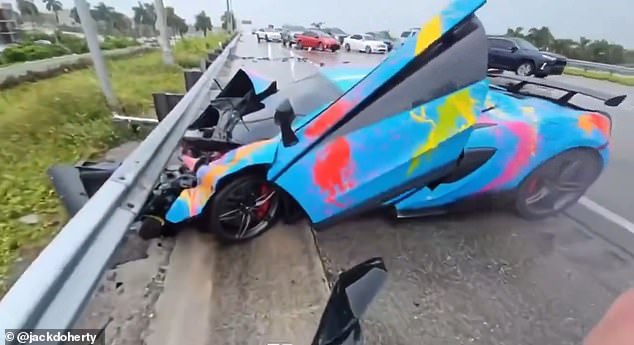 The customized McLaren 570S skidded on the wet road in Miami before hitting the metal barrier on the side of the road, ripping off the hood and destroying the entire front half of the car.