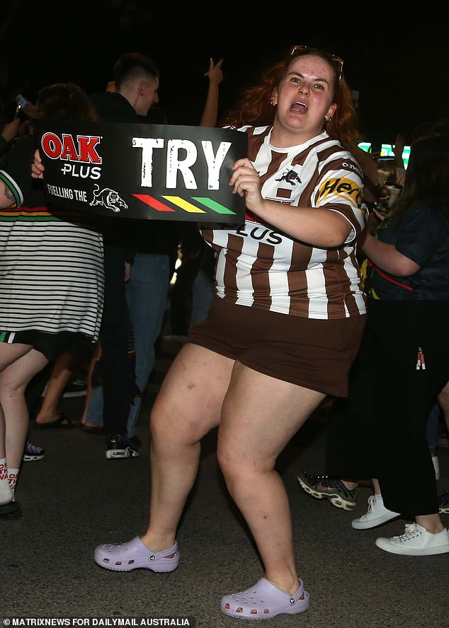 A die-hard Penrith is shown holding the try sign she no doubt held up for each of the Panthers' three tries.