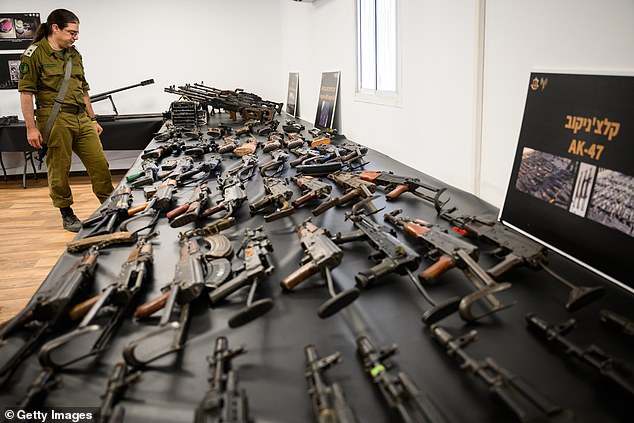 A series of AK-47s are seen on the screen set up by the IDF.