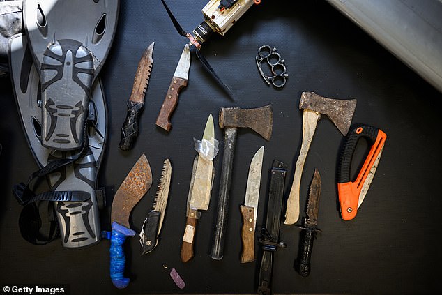 Recovered blades and knives used by Hamas members during the October 7 attacks are seen during an IDF exhibition.