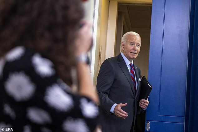 US President Joe Biden jokes with the media as he leaves the daily press briefing in the White House press briefing room.