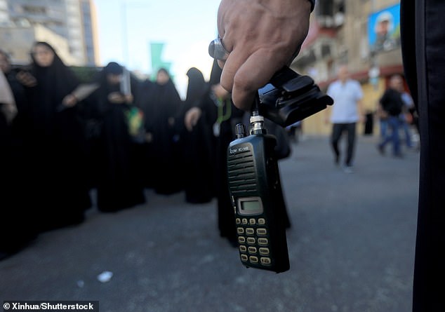 Photo taken on September 18, 2024 shows a wireless communication device in the hand of a Hezbollah member, whose battery was removed after a wireless communication device exploded during a funeral, in Beirut, Lebanon.