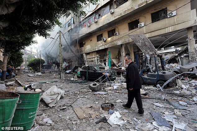 A man walks through rubble at a site damaged after Israeli attacks in the southern suburbs of Beirut.