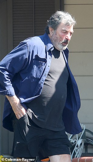 Exclusive photos from DailyMail.com show Selleck dressed in a blue button-down shirt, black T-shirt, shorts and sneakers, and carrying a folder full of papers.