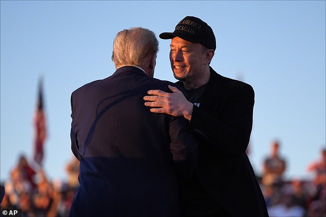 Elon and Trump hug on stage after he jumped for joy to meet him