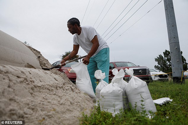 Lenard Cox prepares sandbags to be distributed to Pinellas County residents ahead of Tropical Storm Milton's expected arrival in Seminole, Florida, on Sunday.