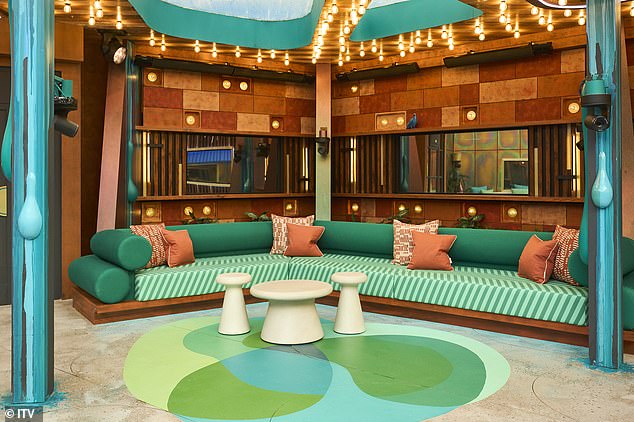 A canopy area includes a green and pink striped sofa with overhead lights.