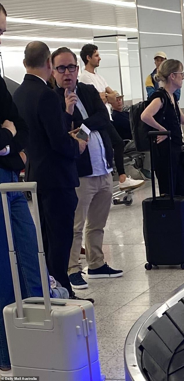 The former Qantas boss was seen chatting to another man while waiting for his luggage at the Sydney Airport carousel early on Monday morning, having arrived from an overseas trip.