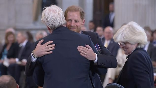 Prince Harry hugs his uncle, Charles Earl Spencer, while his aunt Lady Jane Fellowes stands nearby at the 10th anniversary of the Invictus Games in May.