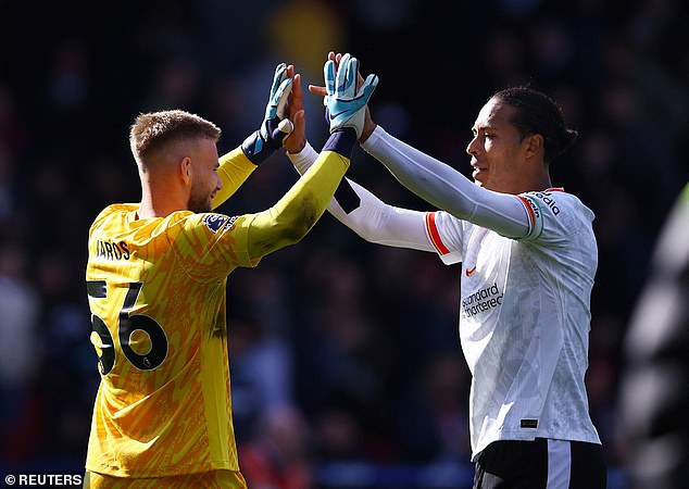 Liverpool captain Virgil van Dijk celebrates with the goalkeeper after his clean sheet.