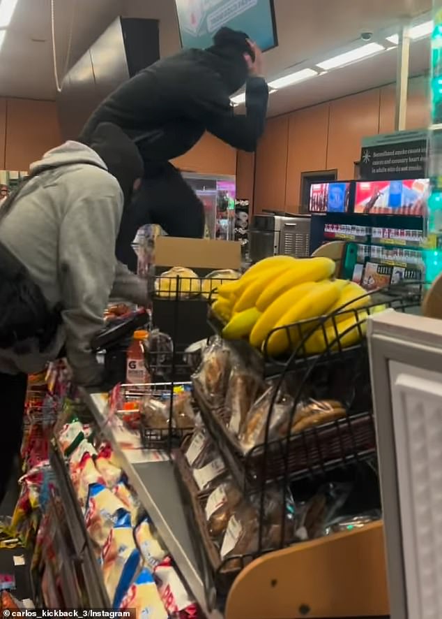 The criminals climbed on the counter while destroying the store.