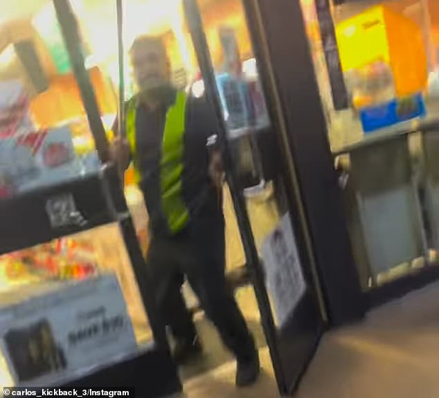 The store clerk raised a broom to try to scare away the teenagers.