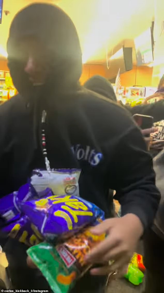 One of the robbers left the store with a smile on his face and his arms full of bags of chips.