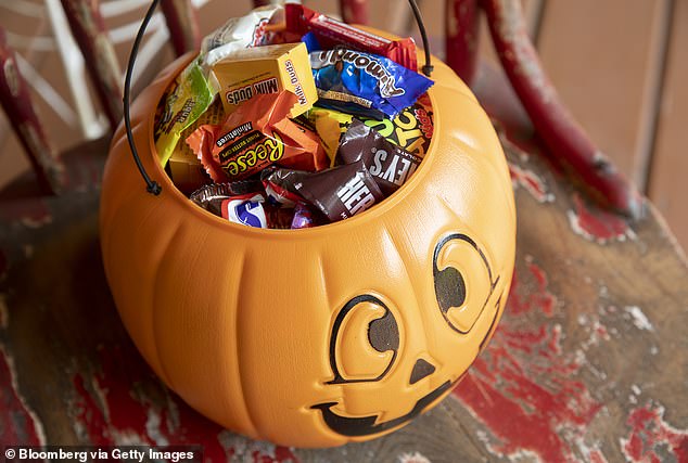 A plastic pumpkin full of candy for children on Halloween (file image)