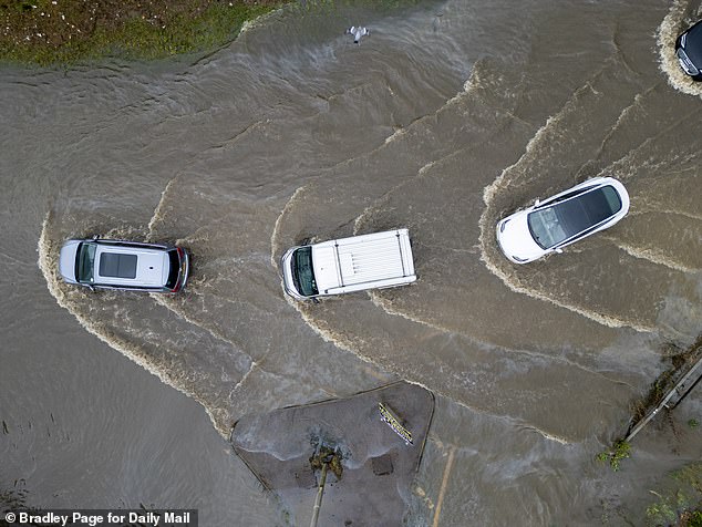 Don't do this! Driving through water behind other cars is a bad idea, as you can end up in a queue or get stuck behind a stranded car and increase the chance of water getting into your car's engine.