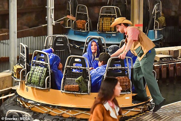 Wearing waterproof hooded sports jackets, the family let loose on the ride, which is based around Disney's Animal Kingdom's treacherous Kali River Rapids.