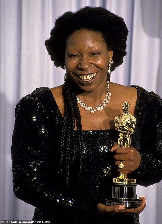 Whoopi posing with her Oscar statuette for Best Supporting Actress at the 1991 Academy Awards