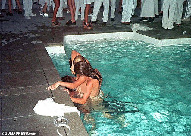 Two women pour champagne down a third woman's throat at Combs' Labor Day party at his East Hampton home in 1998.