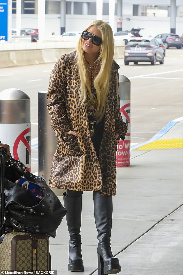 The star donned a plunging print slip paired with a leopard print coat for her outing.