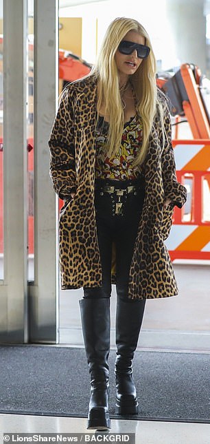 She showed off her very slender figure in leather leggings and platform boots, accessorizing them with chic shades, gold jewelry and pink lip gloss.