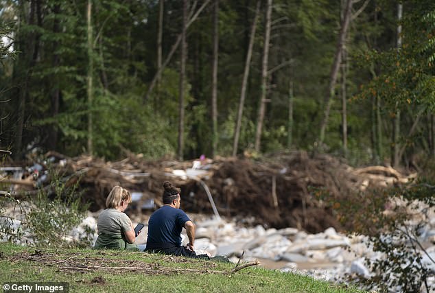 People view flood damage following Hurricane Helene on October 3, 2024 in Bat Cave, North Carolina. More than 220 people died due to the storm