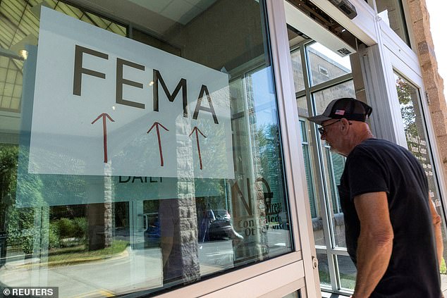 A resident enters a makeshift FEMA station to handle claims from local residents affected by flooding following Hurricane Helene in Marion, North Carolina, on October 5, 2024.