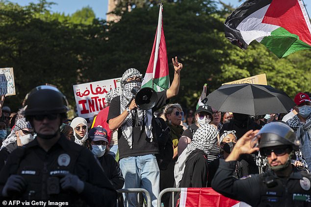 People inside an encampment on the University of Washington campus protest the university's ties to Israel and Boeing in Seattle, May 12, 2024.