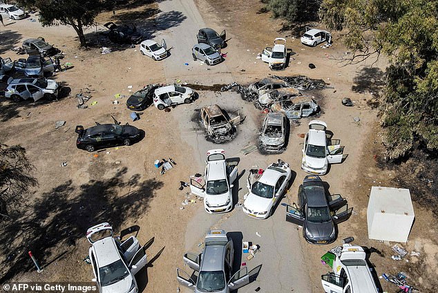 This aerial image shows abandoned and burned vehicles at the site of the October 7 attack on the Supernova desert music festival by Palestinian militants near Kibbutz Reim in the Negev Desert in southern Israel on October 13, 2023.