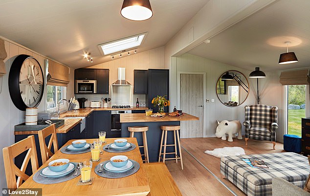 Shown here is the hostel's kitchen with a breakfast bar, coffee maker, dishwasher and washing machine.