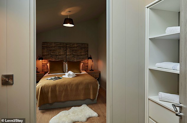 This image shows the master bedroom with its king size bed and walk-in closet.