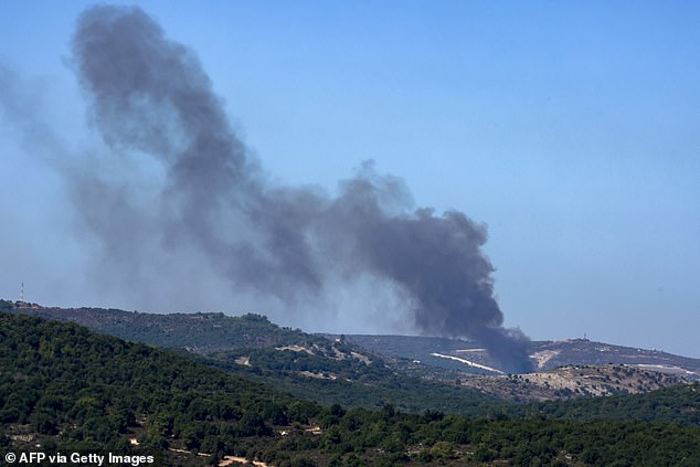 A photograph taken on October 8, 2024, from a position in northern Israel, near the Lebanese border, shows smoke billowing following Israeli bombing of Lebanese territory.