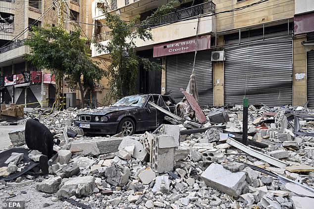 A damaged car under the rubble of a building following an Israeli airstrike in the Dahieh district of Beirut, Lebanon, on October 8, 2024.