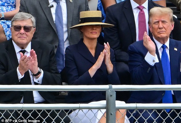 Melania Trump (center) is seen at Barron Trump's high school graduation with her father, Viktor Knavs (left) and former President Donald Trump (right). In his new book, he insists that his father was not really a communist, other than being a member of the party.