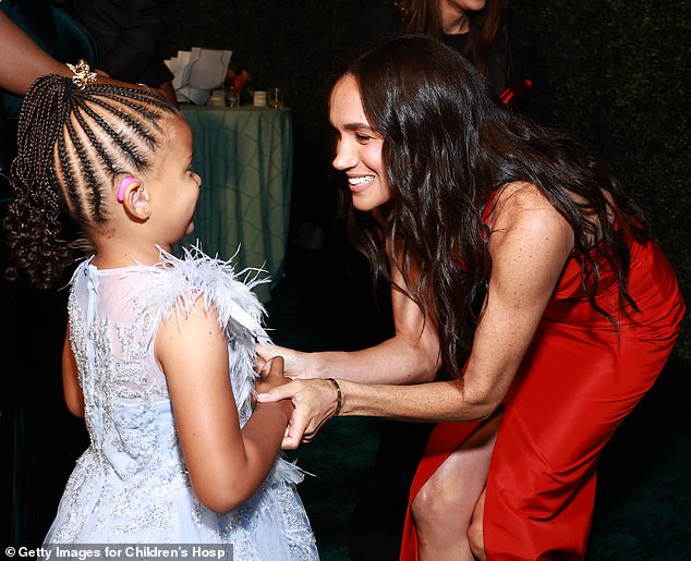 Leaning down to meet young Ella Nelson at the Children's Hospital Los Angeles Gala on Saturday showed why it's unwise to wear a split dress on such occasions.