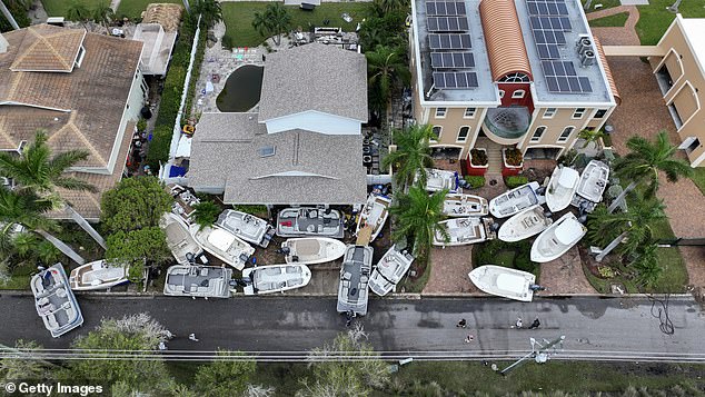 Pictured: Boats crash into homes and businesses on Treasure Island after Helene brought record storm surge to Florida's west coast.