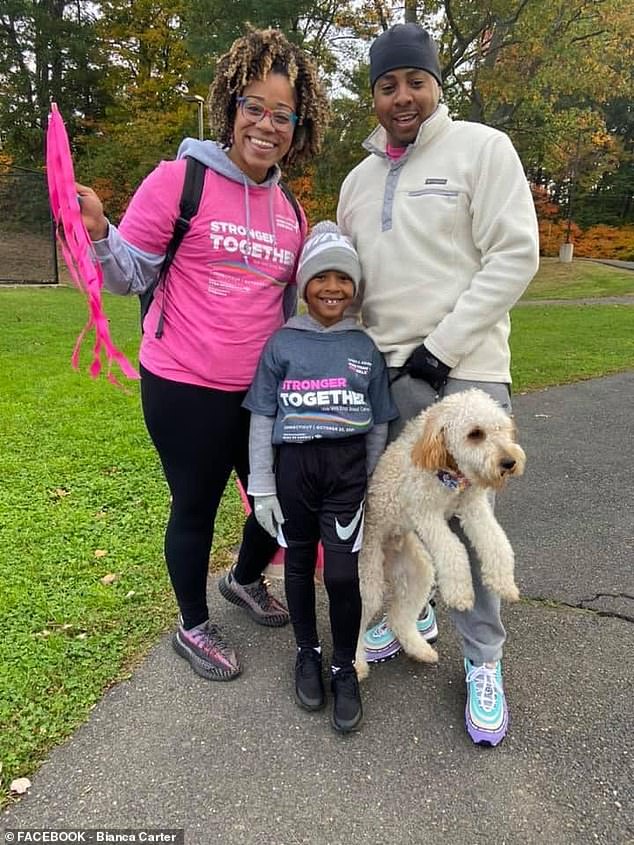 Mrs Carter, pictured with her husband, son and dog, said her cancer required her to undergo a hysterectomy, depriving her of the opportunity to have a big family.