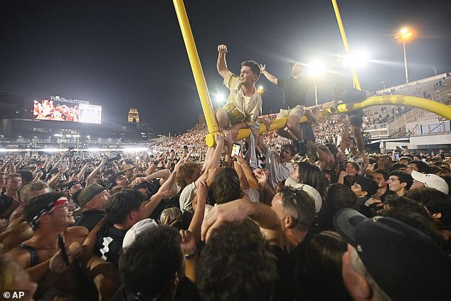 Fans stormed the field and tore down the goal post after the biggest win in school history.