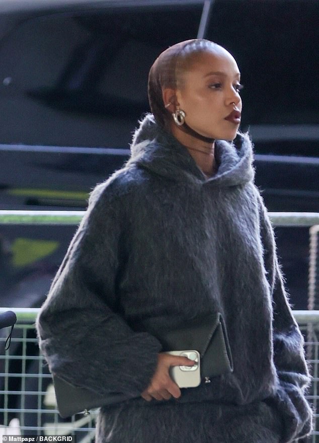 She paired the chunky shoes with a furry gray tracksuit while keeping her hair out of her face in tight braids.