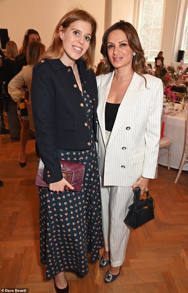 The princess added inches to her figure in a pair of burgundy heels and carried her belongings in a matching clutch; Pictured with Anu Hinduja.