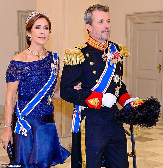 For the banquet, which was held at Christiansborg Palace in the country's capital, the mother of four (pictured, left) opted for a long dress with a lace top and tiered skirt.