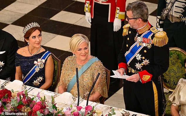 ROYAL COUPLE: Queen Mary (pictured, left) was photographed smiling at her husband King Frederik (pictured, right) as he gave a speech (President Halla Tomasdottir appears in the center)