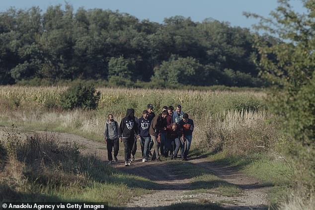 Migrants cross the border between Slovakia and Hungary near Vyskovce Nad Iplom, Slovakia, on September 6, 2023.