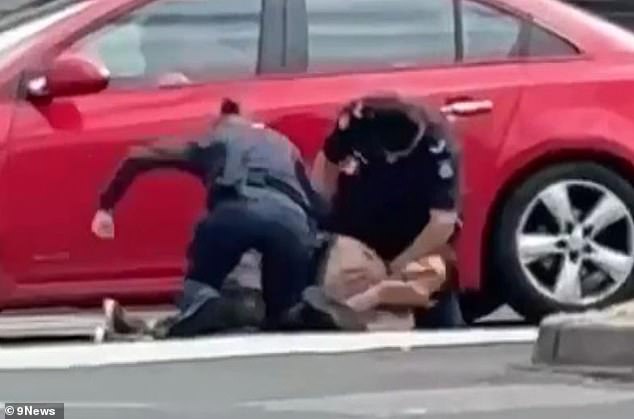 In the images, a female officer is seen hitting the shirtless man several times (pictured).