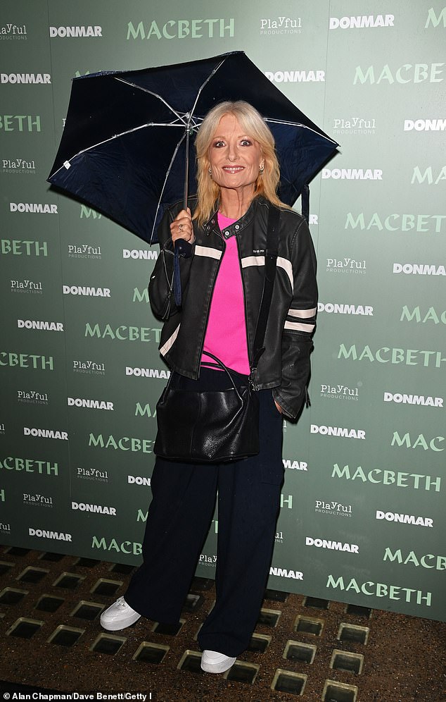 TV presenter Gaby Roslin cut a modern figure in a bright pink top and navy blue trousers as she posed outside the theatre.