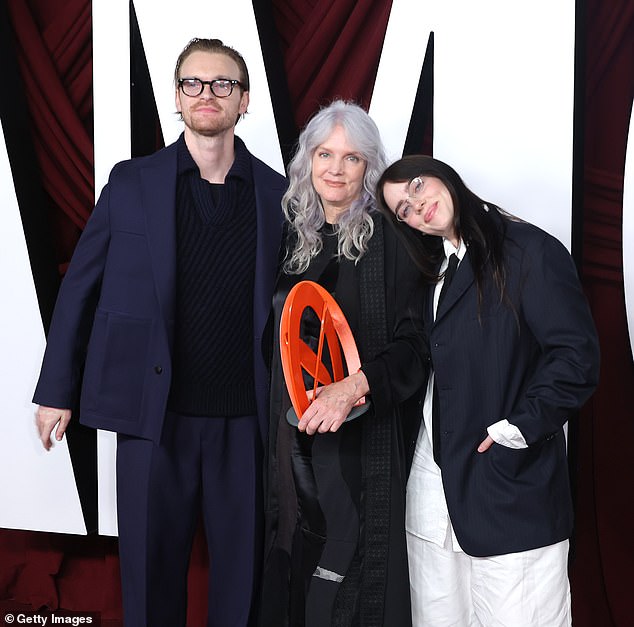 Beside him, Billie sported an oversized striped jacket, which he layered over a white button-down shirt and a black satin tie. Finneas also dressed to impress, opting for a monochrome navy ensemble.