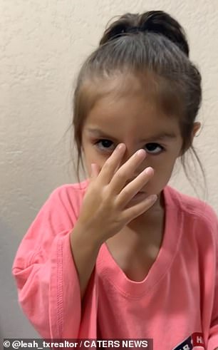 The young woman rubs her forehead after waxing.