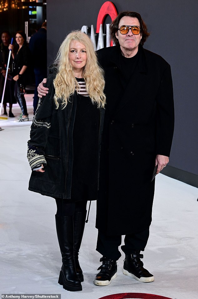 Jane looked chic in a black dress with a striped blouse underneath and a gray denim jacket.